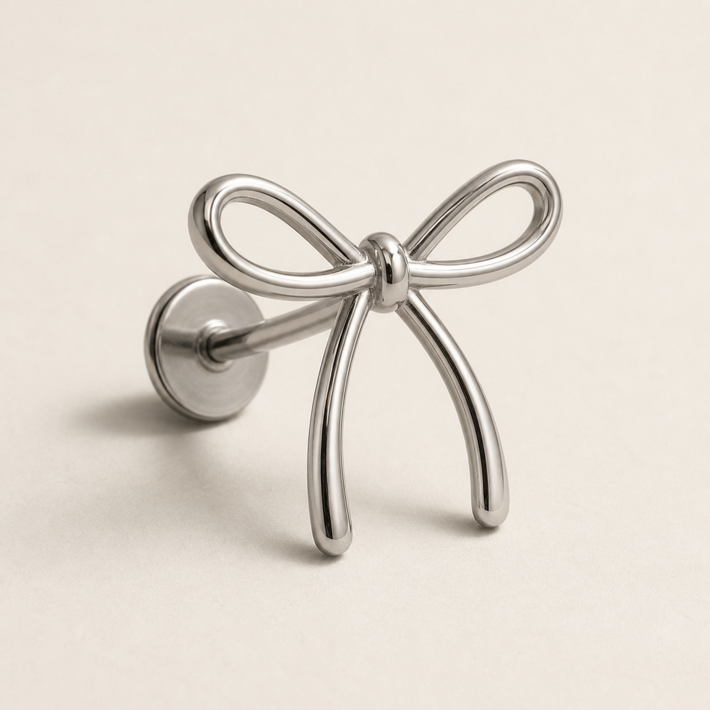 Titanium Flat Back Earrings – Outline Bow Cartilage Stud - product view Titanium Flat Back Earrings – Outline Bow Cartilage Stud - product view