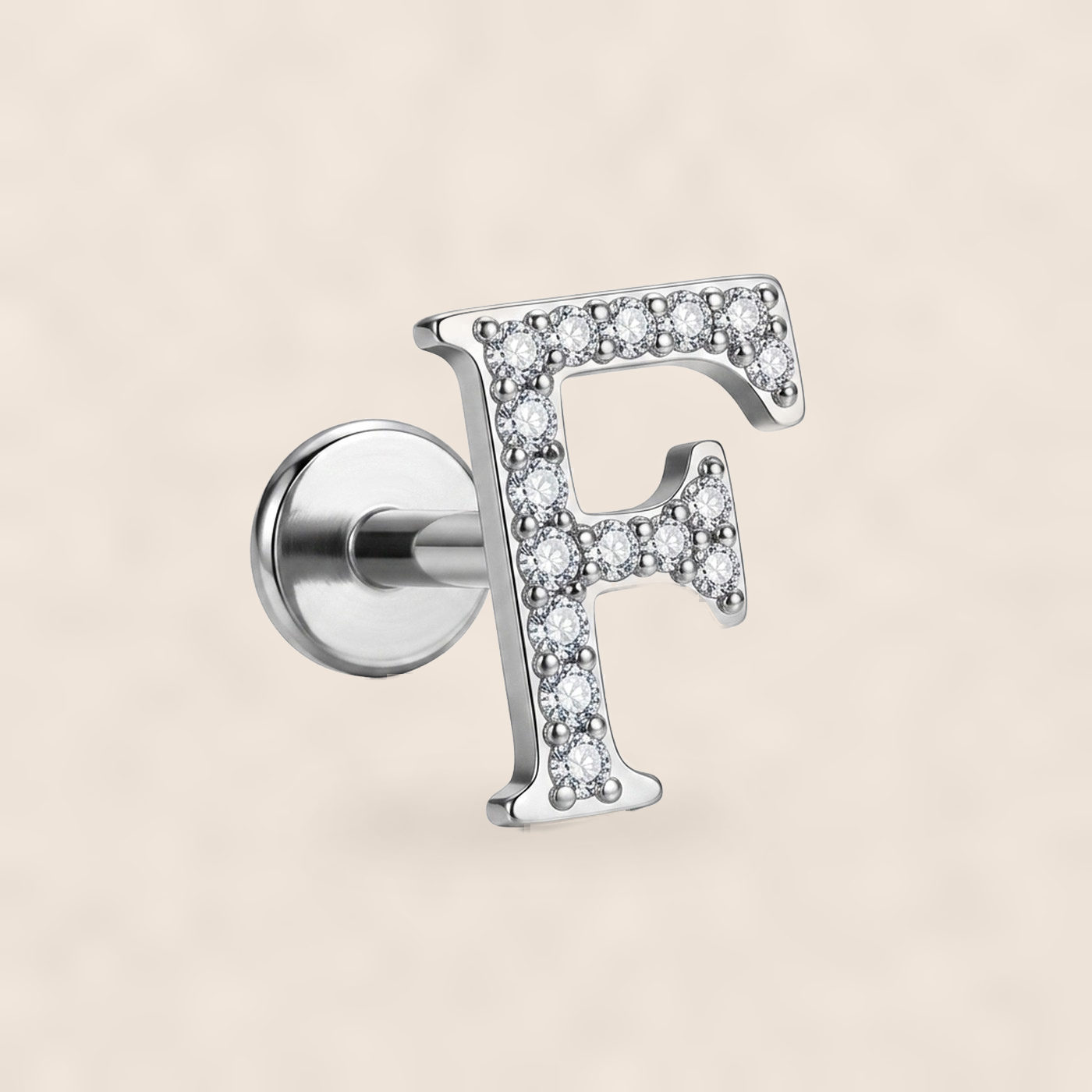 Flat Back Stud Earrings Letter F in F136 Titanium on warm ivory background