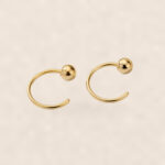 Hypoallergenic Hoop Earrings Ball with S925 Silver on warm ivory background