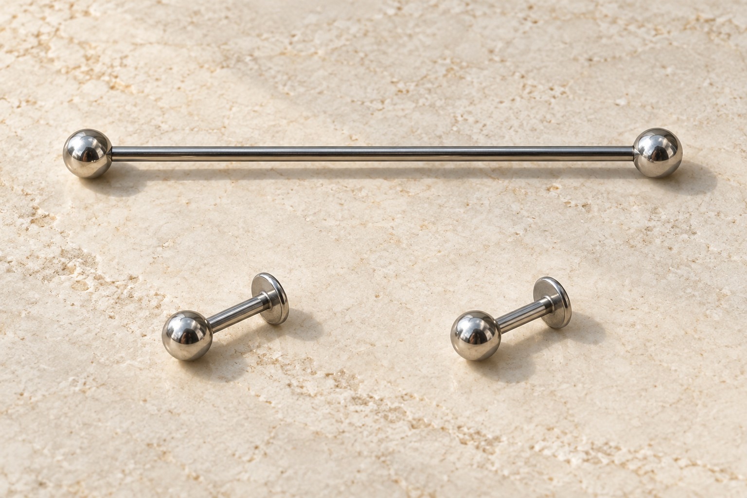One long straight barbell above two separate short flat-back studs.