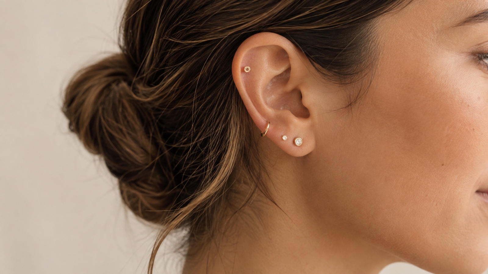 Adult wearing an understated asymmetrical ear stack with deliberate spacing