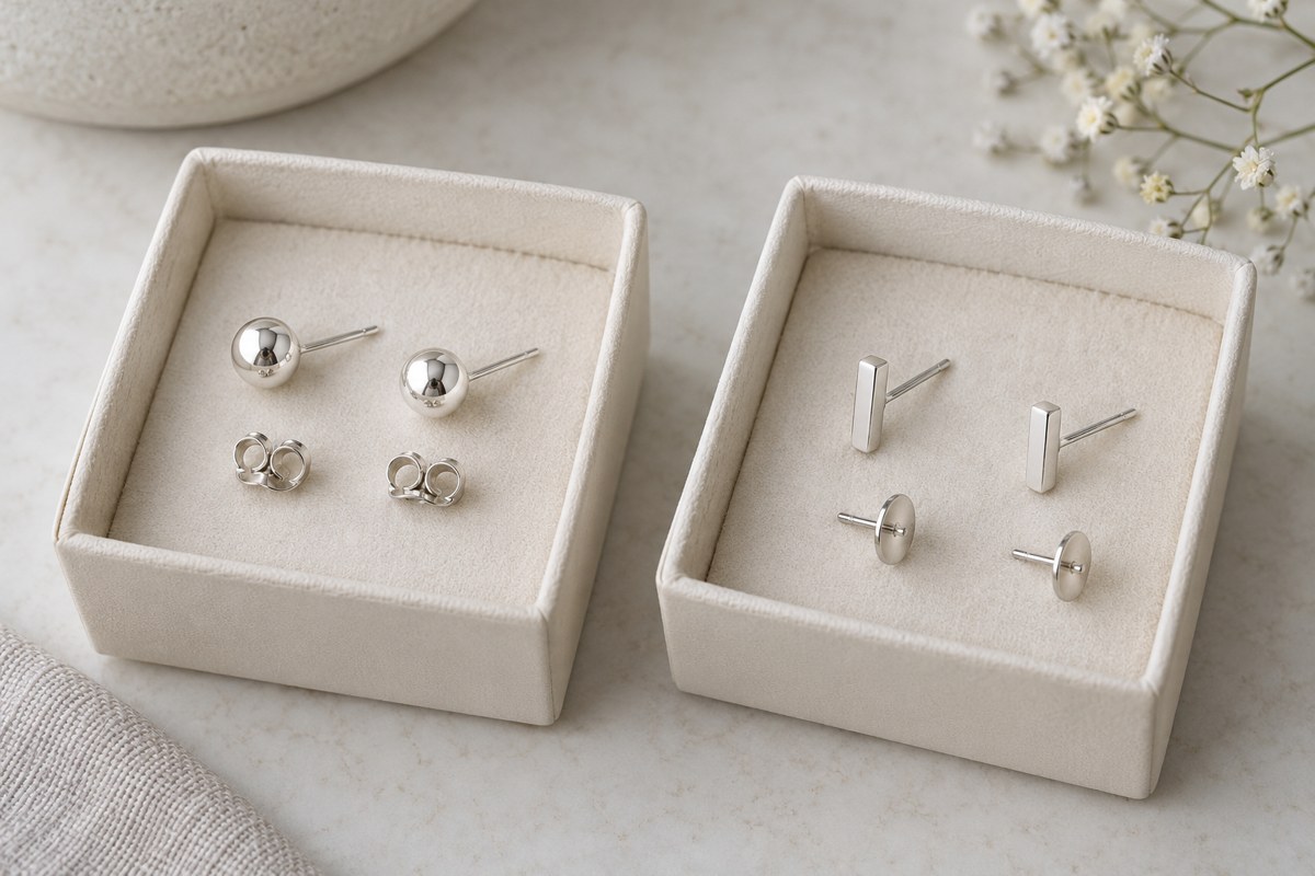 Ball studs and bar studs with separate backs in two jewelry trays.