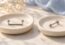 A staple-shaped surface bar and a separate straight flat-back stud on two dishes.