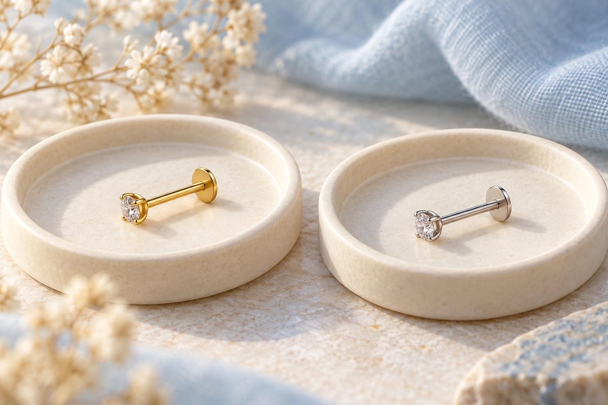 Gold-colored and silver-colored crystal-front flat-back studs on separate dishes.