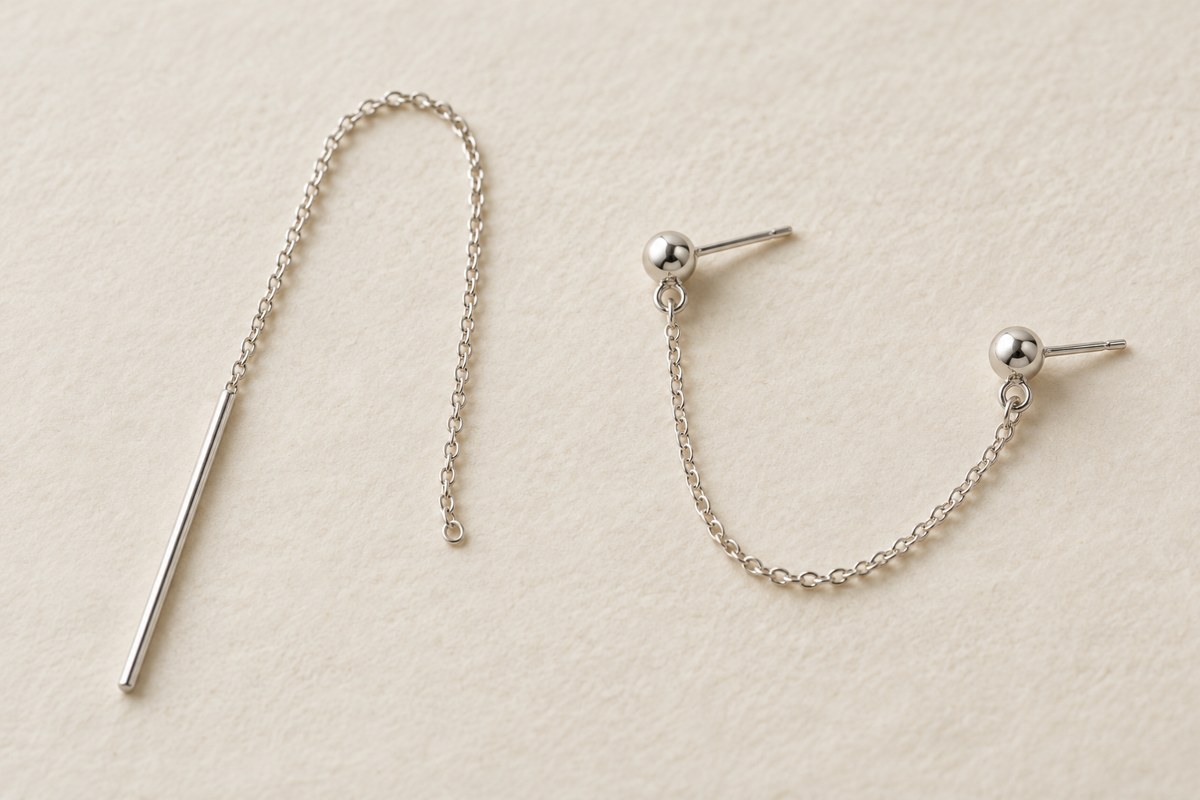 A single silver-colored threader beside a chain joining two ball studs; generic jewelry illustration.